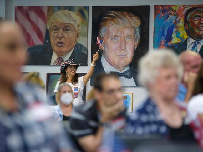 A woman waves an American flag as Trump supporters watch the presidential debate at the Trump Victory Campaign centre in Katy, Texas. Picture: AFP