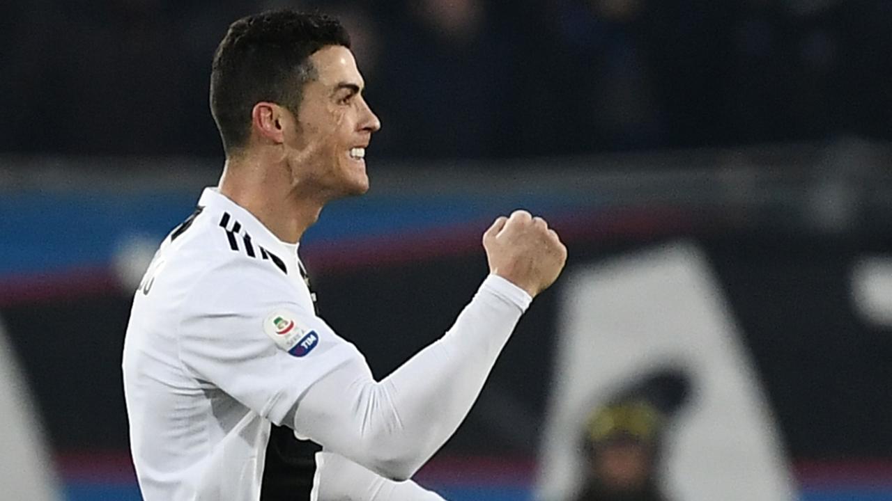 Cristiano Ronaldo celebrates after scoring. (Photo by Marco BERTORELLO / AFP)