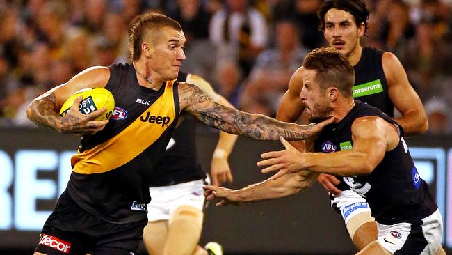 Richmond v Carlton, at the M.C.G. 24th March, Melbourne Australia. Richmond's Dustin Martin with the fend off Picture : George Salpigtidis