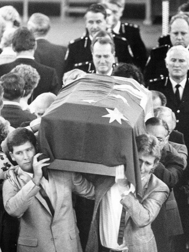 Mourner carry the coffin of murder AFP assistant commissioner Colin Winchester.