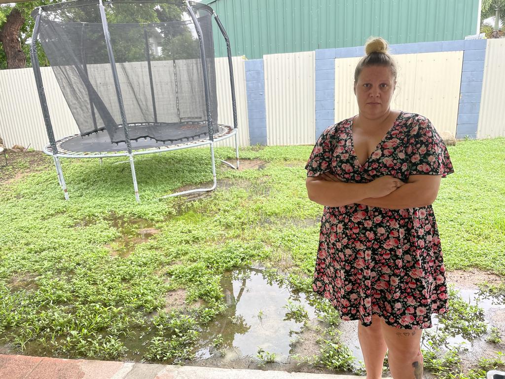 Wulguru resident Brittany Giudes with the sewage pooling in her backyard. Picture: Leighton Smith.