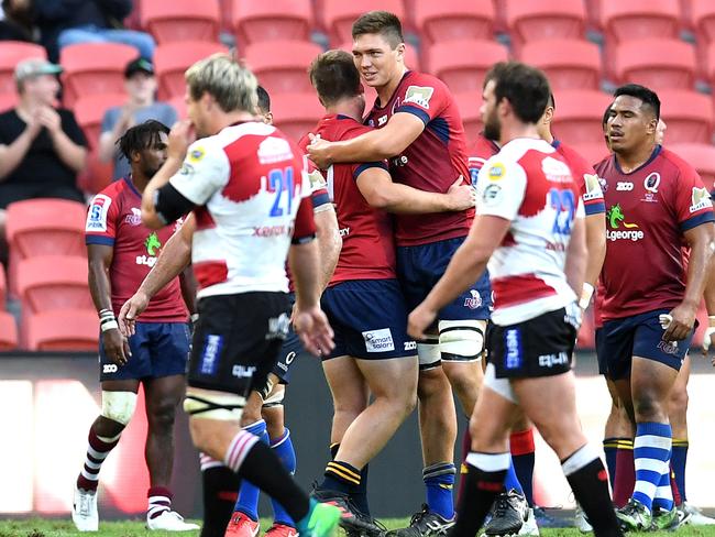 Reds players celebrate their impressive win over the Lions.