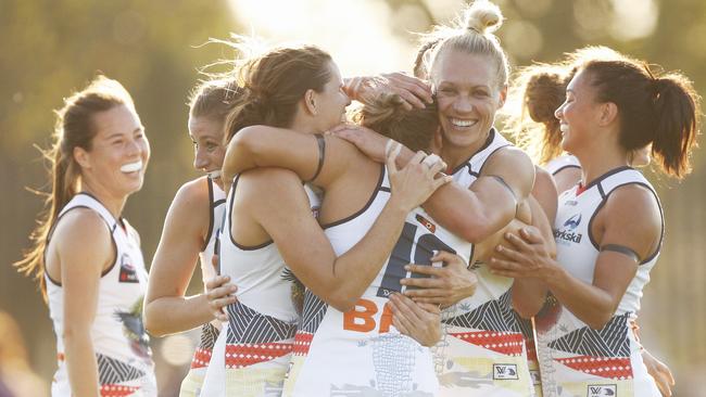 Crows players celebrate an Ebony Marinoff goal.