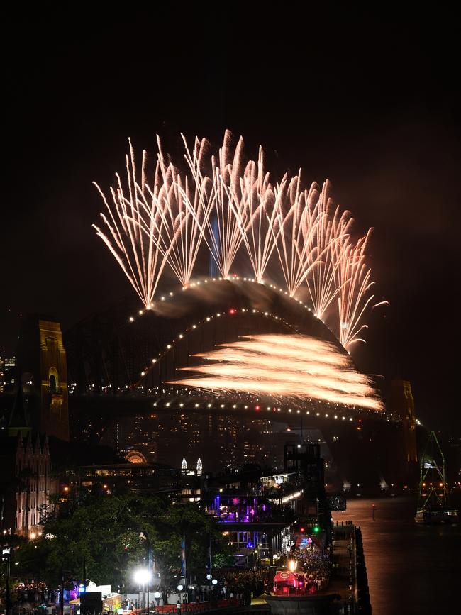 Fireworks explode to welcome in the New Year over the Sydney Harbour Bridge.