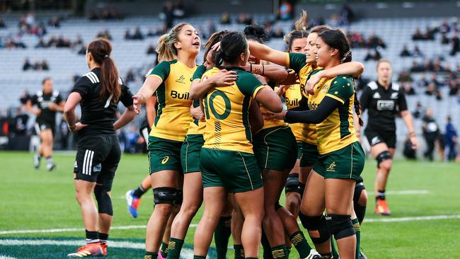 Wallaroos players celebrate a Mahalia Murphy try against the New Zealand Black Ferns.