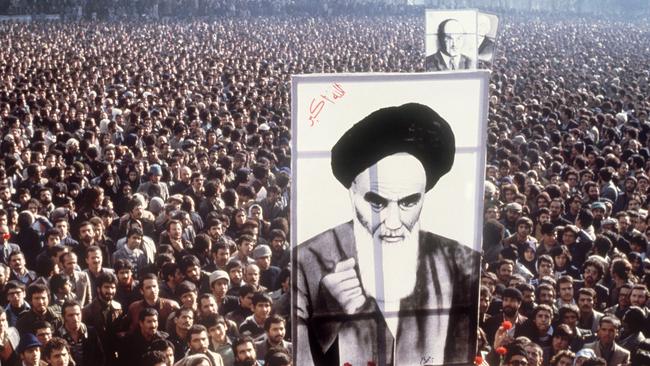 Iranian demonstrators hold a poster of Ayatollah Ruhollah Khomeini in January 1979, during a demonstration in Teheran against the Shah.