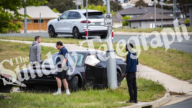 Onlookers walk around the crumpled luxury car owned by Nick Kyrgios. Picture: OnScene ACT