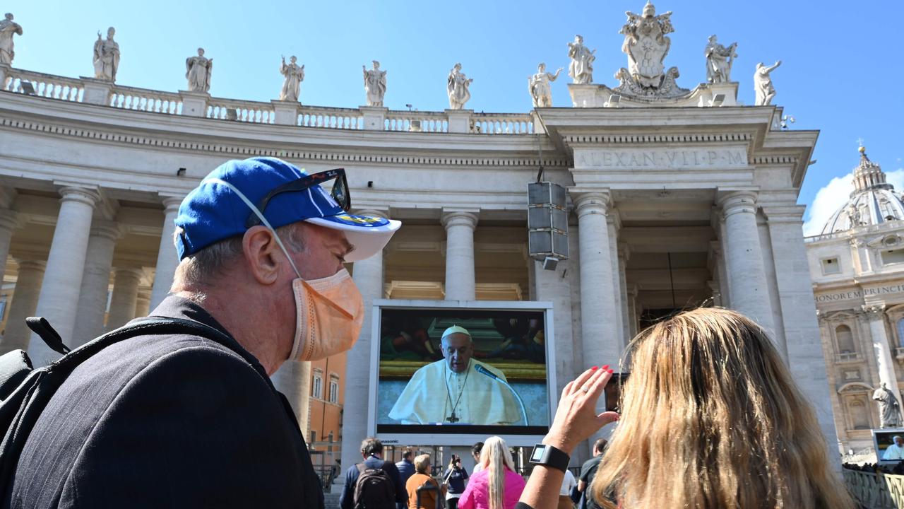 Crowds watch the live-streamed prayers. Picture: Alberto Pizzoli/AFP