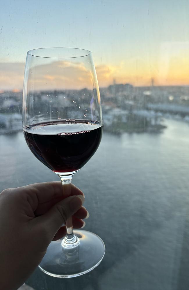 Of course, I ended my bougie staycation the way any billionaire would, with a million dollar view and a glass of wine. Picture: news.com.au