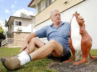 An upset Norm Clapham of Dawson Street in Lismore looks forlornly at his 30-year-old kangaroo statue that was recently decapitated by vandals. Picture:  DAVID NIELSEN