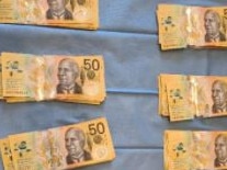 Some of the cash found by police during their raids.