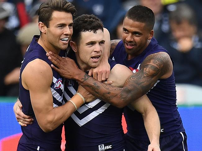 (L-R) Lachie Weller, Hayden Ballantyne and Bradley Hill of the Dockers react after Ballantyne kicked goal during the Round 14 AFL match between the Geelong Cats and the Fremantle Dockers at Simonds Stadium in Geelong, Sunday, June 25, 2017. (AAP Image/Julian Smith) NO ARCHIVING, EDITORIAL USE ONLY