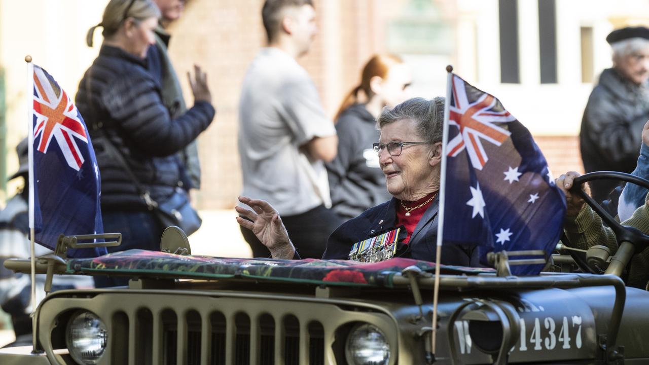 Jean Dellit waves from a Willys in the march to the Mothers' Memorial for the mid-morning Toowoomba Anzac Day service, Tuesday, April 25, 2023. Picture: Kevin Farmer