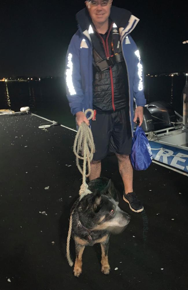 Mike Looney with River after the VMR Bribie Island crew rescued her from a sinking house boat. Picture: Marine Rescue Bribie Island 445