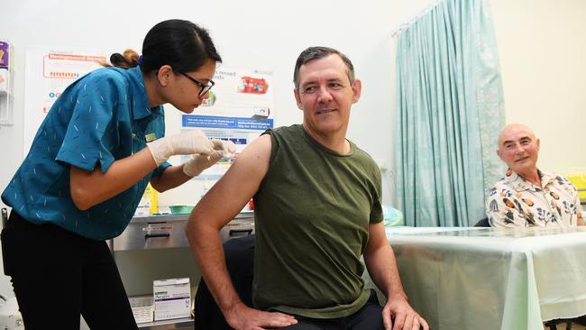 Chief Minister Michael Gunner receives the first dose of the coronavirus vaccine, with nurse Nizma Tamrakar. Picture Katrina Bridgeford.