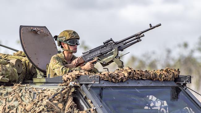 Exercise Talisman Sabre 2019. A soldier mans a light machine gun aboard a bushmaster during a live fire exercise.