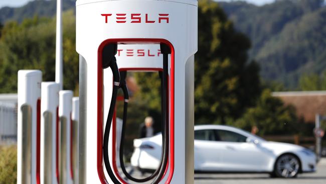 Companies such as Ampol, working with Tesla, are piloting electric-vehicle charging infrastructure. Picture: Bloomberg