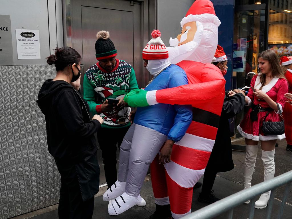 Revellers have vaccine cards checked at a bar as they take part in the SantaCon 2021 in New York. Picture: AFP