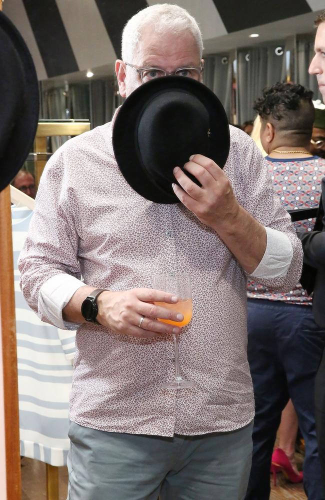 Founder and CEO of Ted Baker, Ray Kelvin, who notoriously obscures his face as he poses for photos. Picture: Astrid Stawiarz