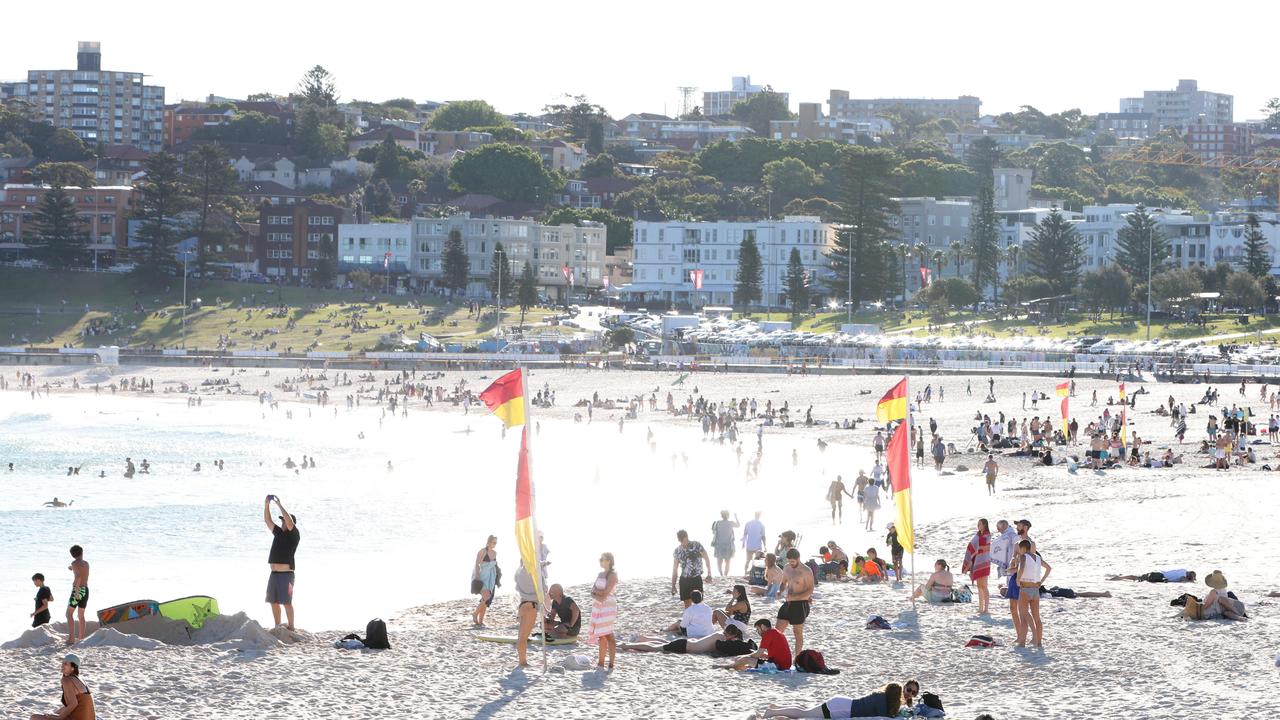 Christmas may be spent indoors this year as rain is expected throughout December. Pictured: People down at Bondi beach on a windy afternoon in November. Picture: Damian Shaw