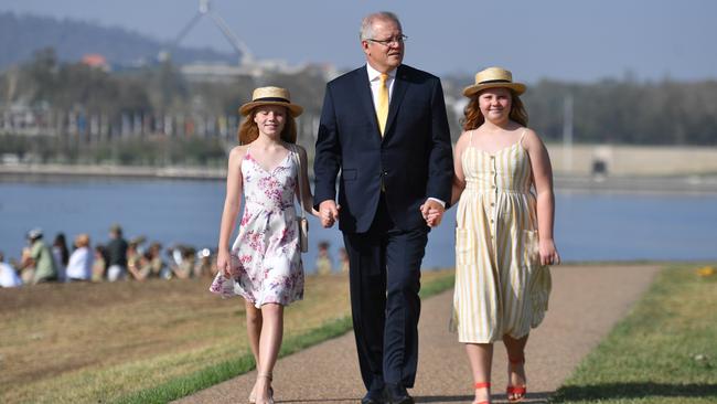 Prime Minister Scott Morrison and daughters Abbey and Lily arrive at an Australia Day citizenship ceremony and flag raising event. Picture: AAP