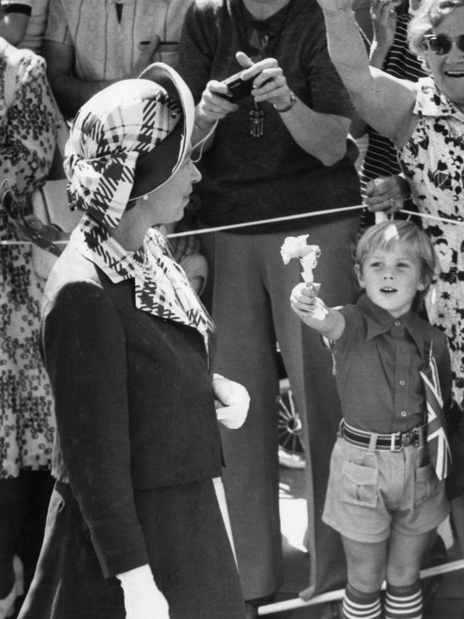 Daniel Allon, 4, of Modbury Heights offers flowers to the Queen.