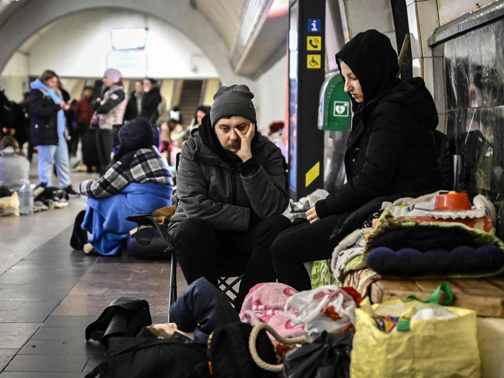 A couple sits in an underground metro station used as bomb shelter in Kyiv. Picture: AFP