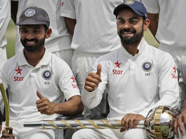 India's captain Virat Kohli, center gestures as the team poses with the Border-Gavaskar Trophy after winning the test cricket series against Australia in Dharmsala, India, Tuesday, March 28, 2017. India won the four-match series 2-1. (AP Photo/Tsering Topgyal)