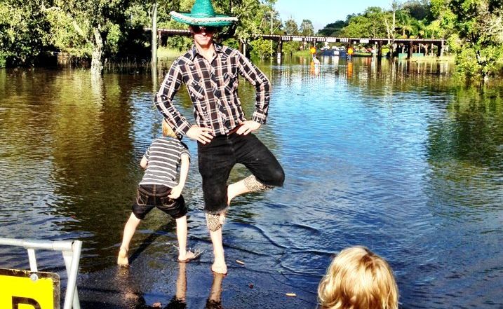 Resident Dean Peachey and his kids enjoy a little welcome sunshine as they survey North Lismore's 'waterfront' properties.