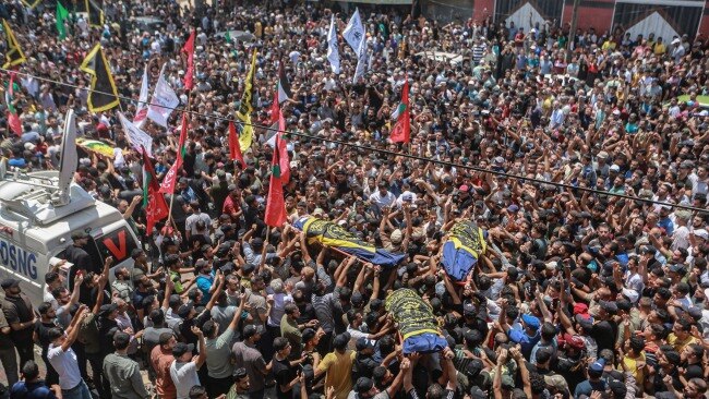 Thousands of Palestinian mourners carry the bodies of victims through the streets in a funeral ceremony while demanding justice. Picture: Mohammed Talatene/picture alliance via Getty Images
