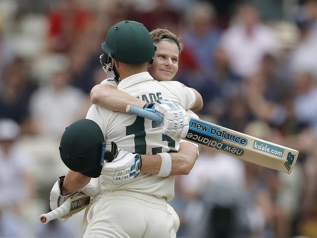 Smith is congratulated by teammate Matthew Wade.