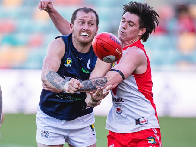 Launceston’s Michael Musicka handballs under pressure from Clarence’s Keren Howlett. Picture: Linda Higginson