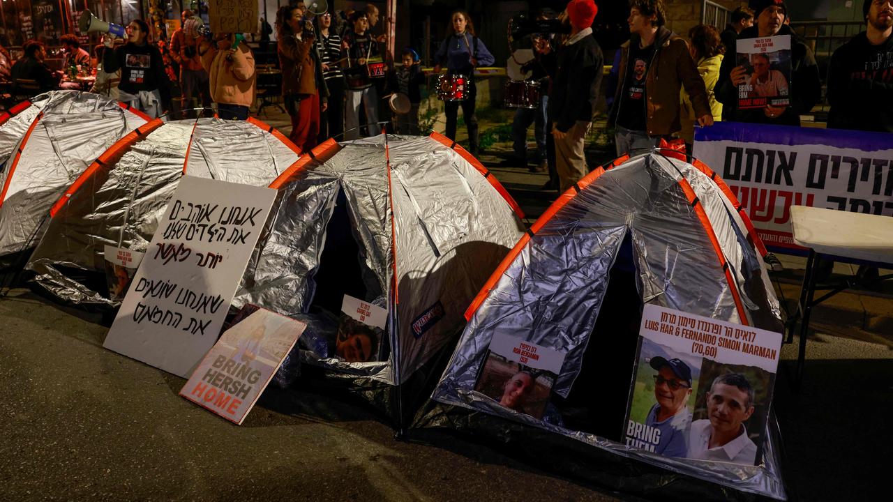 Protesters stand behind tents near the Israeli Prime Minister’s home during a rally organised by family and supporters of Israeli hostages. Picture: AFP