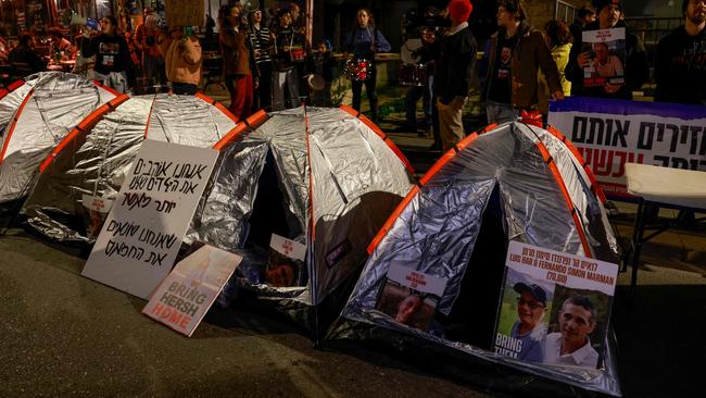 Protesters stand behind tents near the Israeli Prime Minister’s home during a rally organised by family and supporters of Israeli hostages. Picture: AFP