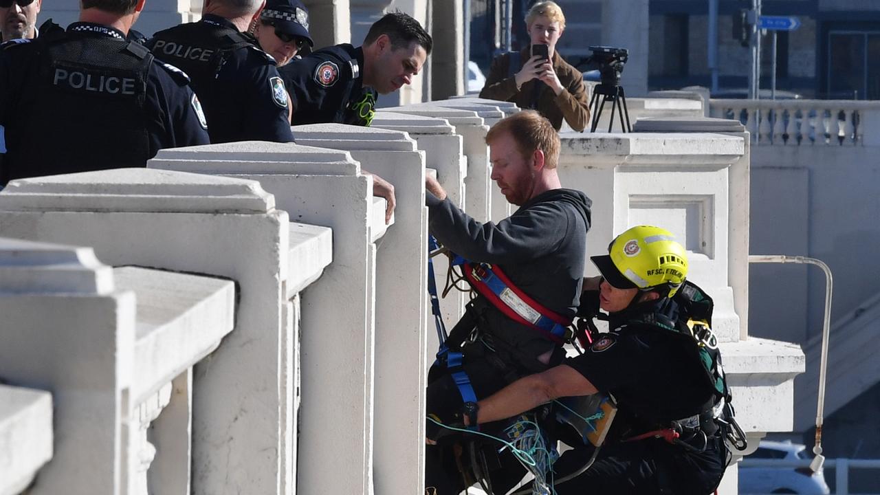 An Extinction Rebellion protestor on the side of the William Jolly Bridge. Picture: Darren England/AAP