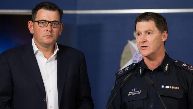 Acting chief commissioner Shane Patton (R) speaks with Premier Daniel Andrews (L). Picture: AFP