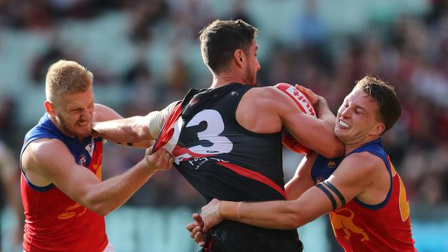 AFL round 4 with Brisbane Lions vs. Essendon Bombers at the MCG. Nick Robertson and Alex Witherden tackle Essendon's David Myers. Picture: Alex Coppel.