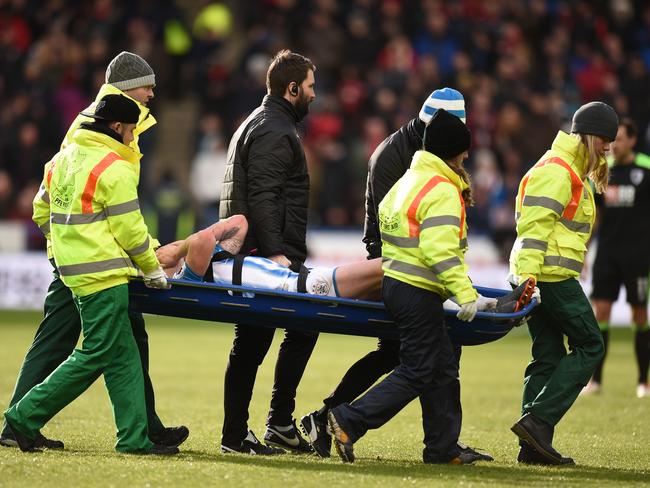 Huddersfield's Australian midfielder Aaron Mooy is stretchered off.