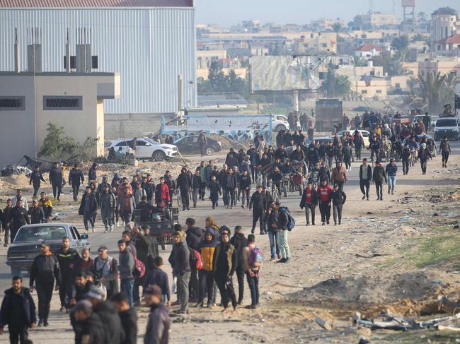 Displaced Palestinians make their way along a street as they return to Rafah on January 19. Picture: Eyad Baba/AFP