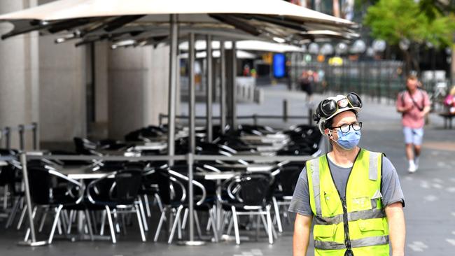 A worker outside a closed restaurant at Circular Quay on Wednesday. Picture: Saeed Khan/AFP