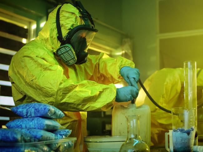 Meth lab generic 2020: In the Underground Drug Laboratory Two Clandestine Chemists Wearing Protective Masks and Coveralls Use Hosepipe For Drug Distillation. They Cook Synthesised Drugs in the Abandoned Building. iStock.