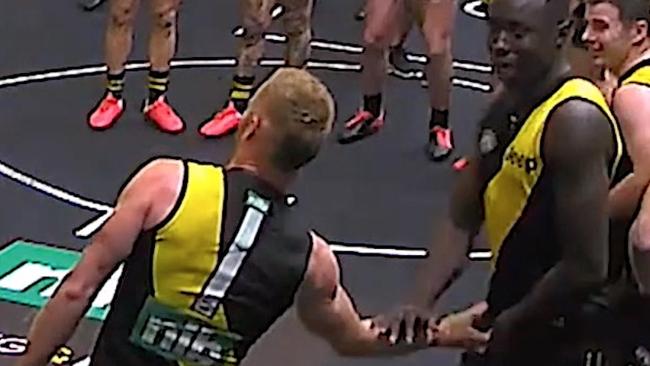 Vlaustin grabs Chol below the belt.