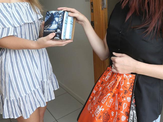 BWS have launched an express delivery service to get alcohol brought to you within the hour. L-R Krystal Ellis at her Hope Island home with BWS Delivery Person Amanda Clogg of BWS Coomera. Picture Mike Batterham