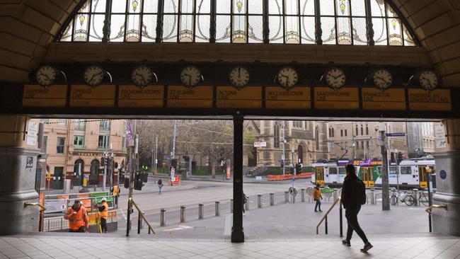 A commuter exits the usually bustling Flinders Street station in Melbourne on July 10. Picture: AFP