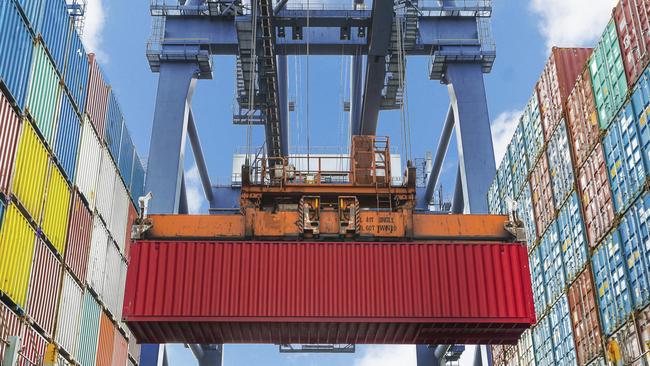 Shore crane lifts container during cargo operation in port