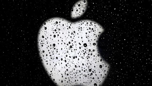 An Apple logo is seen in raindrops on a window outside an Apple Store at the Country Club Plaza shopping district in Kansas City, Mo. (AP Photo/Charlie Riedel, File)