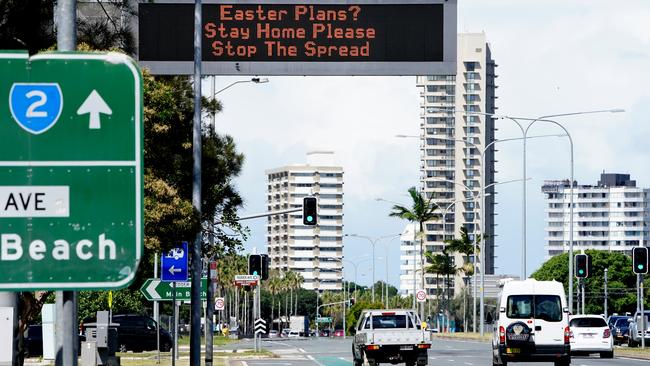 A sign warning to stay home over the Easter period is displayed to motorists on approach to Surfers Paradise on the Gold Coast during a lockdown on Wednesday, April 8, 2020. Picture: AAP Image/Dave Hunt