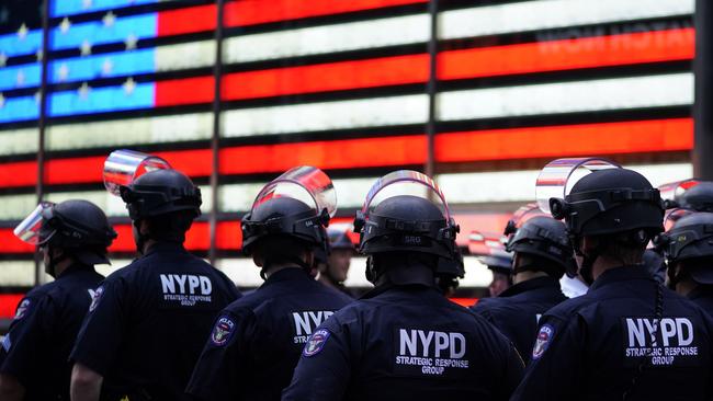 NYPD police officers watch demonstrators in Times Square.