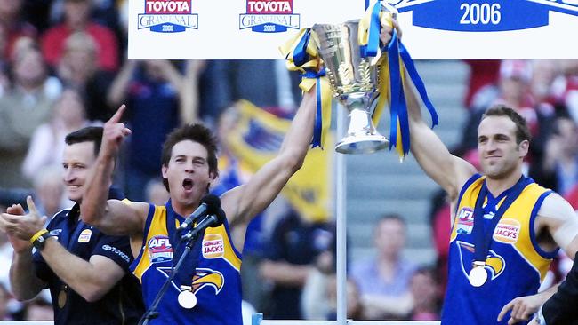 Ben Cousins and Chris Judd with the premiership cup as coach John Worsfold (left) celebrates. Picture: Carmelo Bazzano