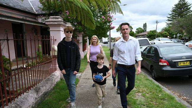 Chris Minns walks with his wife, Anna, and sons Joe, Nick and George for a coffee at a local cafe following his election win.